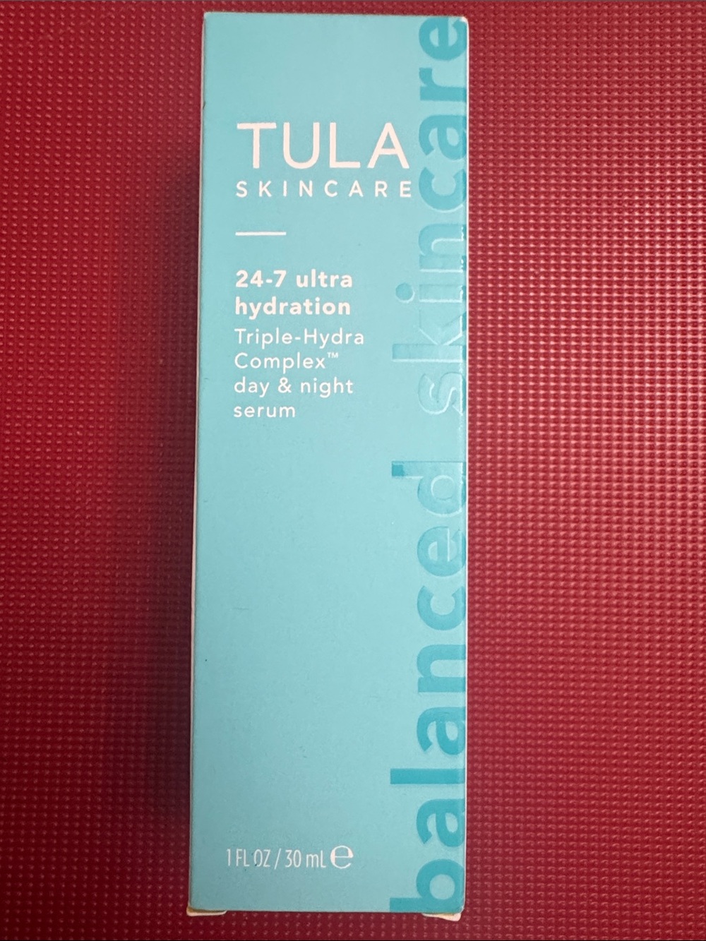 Tula Aqua Blue Skincare Serum Box with Red Background